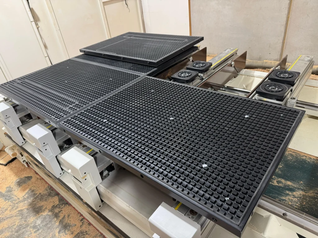 CNC nesting table with vacuum clamping module for woodworking, showing full board machining and stable flat surface fixation